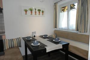a dining room table with cups and saucers on it at Appartement Gwiggner in Niederau