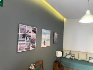 a living room with pictures on the wall at Artemis in Platanias