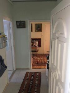 a room with a hallway with a door and a rug at Marika apartman in Hajdúszoboszló