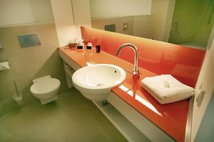 a bathroom with a sink and a toilet at Hotel Ullrich in Elfershausen