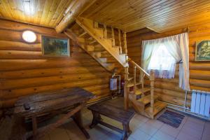 a room with a wooden staircase and a wooden bench at Chastnaya Dacha in Volgograd