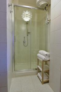a bathroom with a shower with a glass door at Stella Marina in Quartu SantʼElena