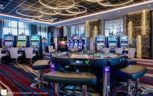 a casino with a bunch of slot machines and stools at Impérial Palace in Annecy