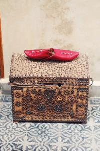 a red shoe sitting on top of a suitcase at Riad Anata in Fez