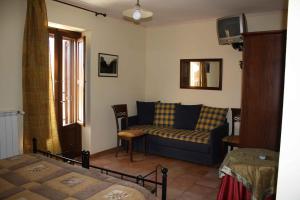 a living room with a couch and a bed at Locanda del Barone in Caramanico Terme +59 photos