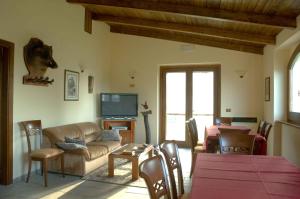 a living room with a couch and a tv at Locanda del Barone in Caramanico Terme