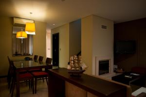 a living room with a table and a dining room at Noiva do Mar in Lourinhã