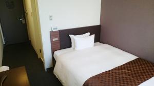 Postel nebo postele na pokoji v ubytování Hotel Ascent Plaza Hamamatsu