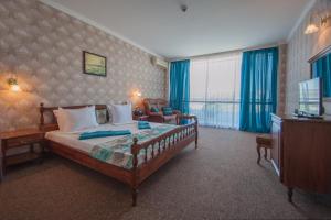 a hotel room with a bed and a television at Mercury Hotel- All Inclusive in Sunny Beach +93 photos