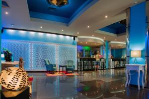 a lobby with blue walls and chairs and a bar at Mercury Hotel- All Inclusive in Sunny Beach