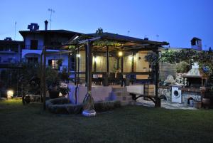 a backyard with a house with a garden at night at Voula Kourbeti Apartments in Agios Nikolaos