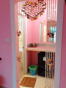 a pink bathroom with a sink and a chandelier at HappyLove1 in Ko Larn
