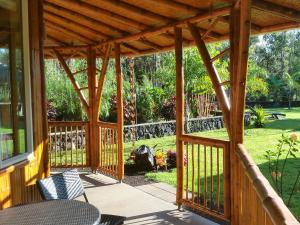 a wooden pergola with a table and chairs on a patio at Volcano Eco Retreat by Heart Core Hotels - Adults Only in Mountain View
