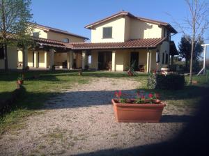 a house with a flower pot in front of it at Oasi Del Verde in Soriano nel Cimino