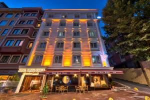a building with tables and chairs in front of it at Santa Sophia Hotel - İstanbul in Istanbul