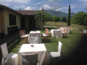 a group of tables and chairs in a yard at Oasi Del Verde in Soriano nel Cimino