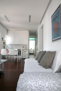 a white room with a bed and a kitchen at Mind-blowing Acropolis View Apt in Athens