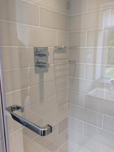 a bathroom with a shower with a glass door at The Garage in Banbury