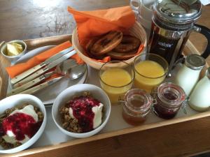 a tray of food with bowls of food and drinks at The Garage in Banbury