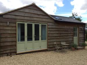 a large shed with a green door on it at The Garage in Banbury