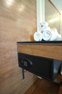 a shelf with rolled towels in a bathroom at Palita Lodge - SHA Plus in Haad Rin