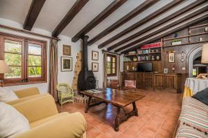 a living room with a table and a fireplace at Can Giro in Pollença