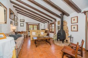 a living room with a couch and a stove at Can Giro in Pollença