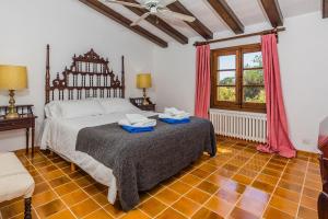 a bedroom with a bed with two towels on it at Can Giro in Pollença +29 photos