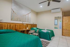a bedroom with a green bed and a bridge on the wall at Hotel Los Chilamates in Granada +87 photos