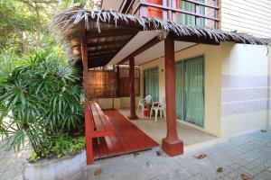 a porch of a house with a wooden deck at Palita Lodge - SHA Plus in Haad Rin