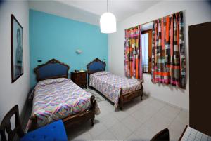 a bedroom with two beds and a desk at Hotel Il Falchetto in Pontedera