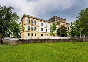 a large building with trees in front of it at One Shot Tabakalera House in San Sebastián