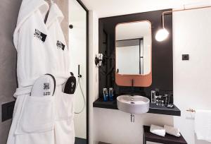 a bathroom with a sink and a mirror at One Shot Tabakalera House in Donostia-San Sebastián