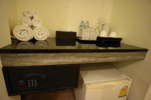 a counter in a hotel room with a pile of towels at Palita Lodge - SHA Plus in Haad Rin