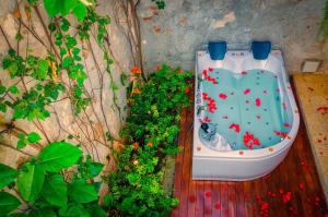 an aerial view of a bathtub with flowers on a deck at Casa Pizarro Hotel Boutique in Cartagena de Indias