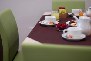 a table with plates of food and cups and drinks at Hotel Soleluna in Piano di Sorrento