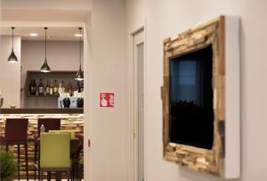 a mirror hanging on a wall in a restaurant at Hotel Soleluna in Piano di Sorrento