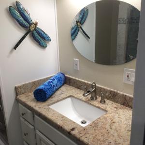 a bathroom with a sink and a mirror at Luxury Beachfront Duplex Villa on Sapphire Beach V in St Thomas