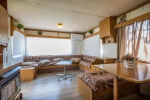 a living room with a couch and a table at Nemeth Camping Spa & Pool Access in Sovata