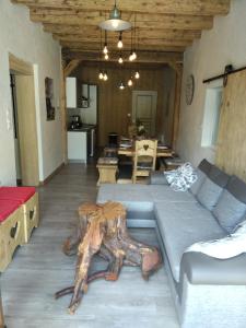 a living room with a couch and a table at Gîte du Charri in Le Tholy