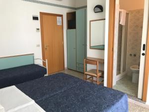 Postel nebo postele na pokoji v ubytování Hotel Luciana