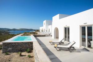 a white villa with a swimming pool and a house at Natura Villas Paros in Molos Parou