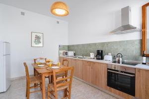 A kitchen or kitchenette at Thea Villas and Suite