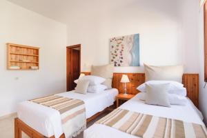 A bed or beds in a room at Thea Villas and Suite