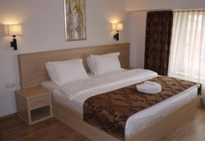 Postel nebo postele na pokoji v ubytování Hotel Pinocchio