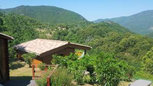 a small house with a view of a mountain at les chalets et gite du haut taravo in Zicavo