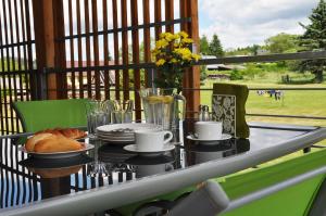 a table with a breakfast of coffee and croissants at Apartmány Stožec - Stela Premium in Stožec