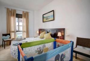 a bedroom with a bed with a crib in it at Apartamento Atenea centro con garaje gratuito in Ronda
