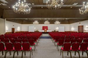 an empty hall with red chairs and chandeliers at Y O Ranch Hotel and Conference Center in Kerrville