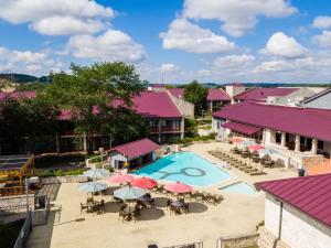 an aerial view of a resort pool with tables and umbrellas at Y O Ranch Hotel and Conference Center in Kerrville